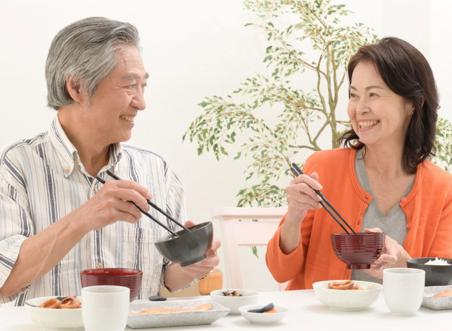 笑顔で食事をする夫婦